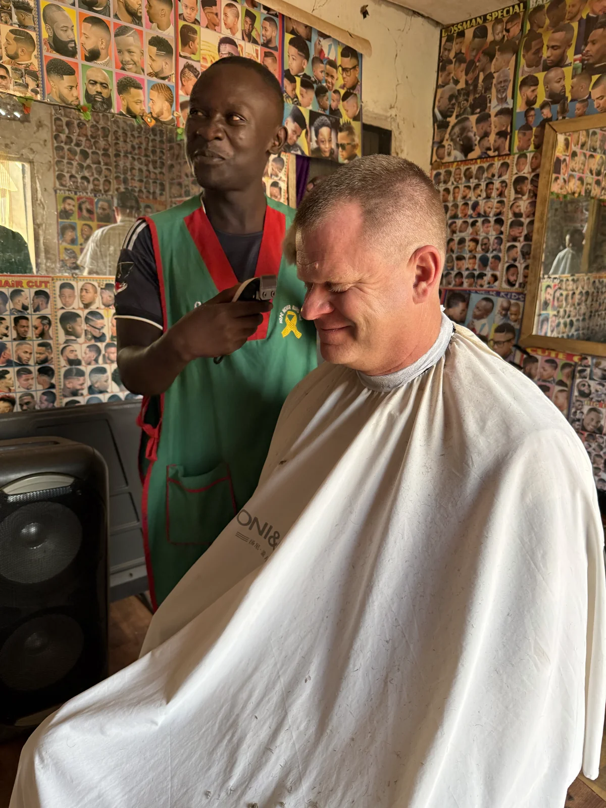 Team member Matt Rader getting his hair done during the January 2026 trip.