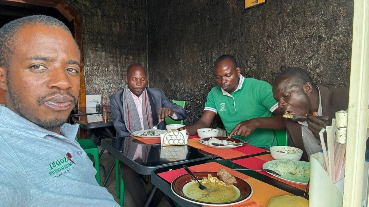 The team sharing a meal after the Kakumiro visit, May 2, 2026.