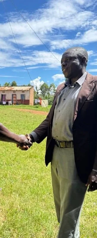 Pastor Sam greets a man at Myanzi, May 3, 2026.