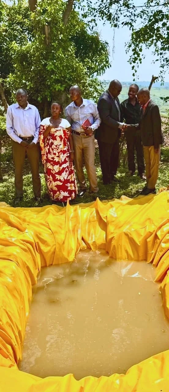 The team and prison officer beside the baptism pool at Farm Kitwe, August 23, 2026.