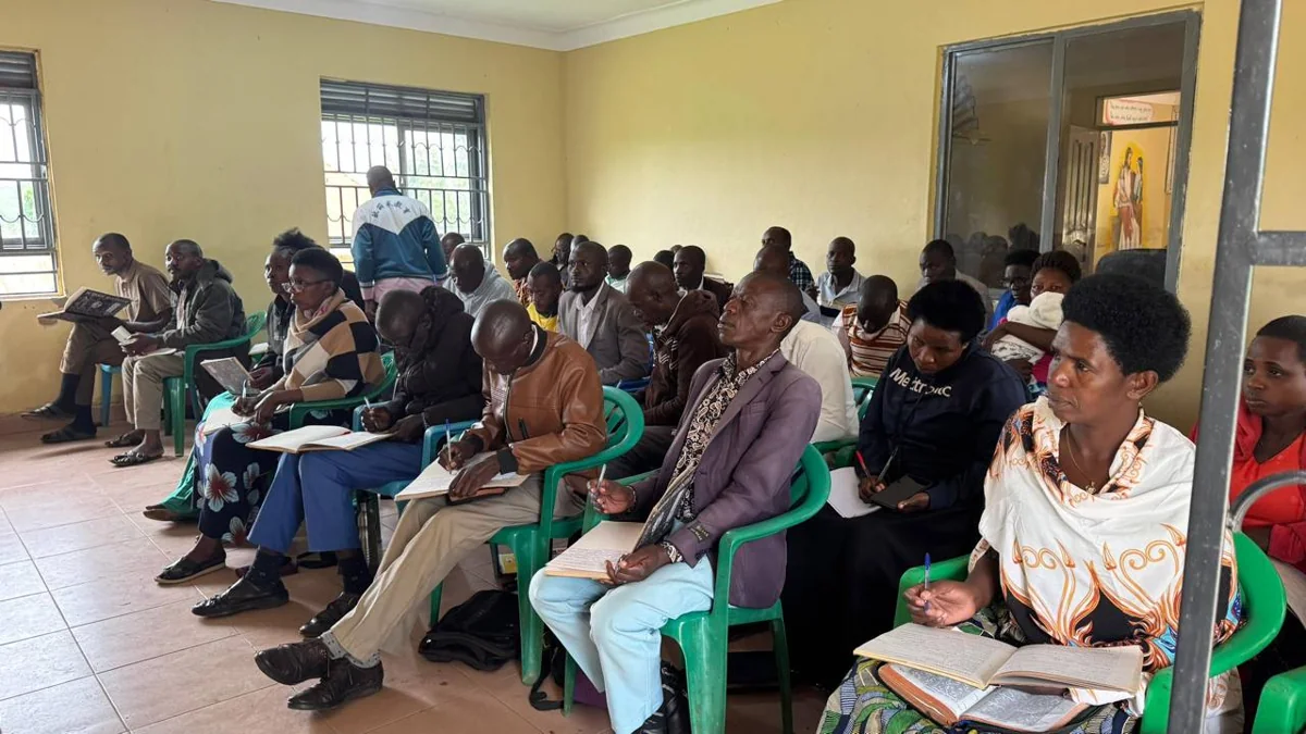 Pastors seated in class with open books and notebooks.