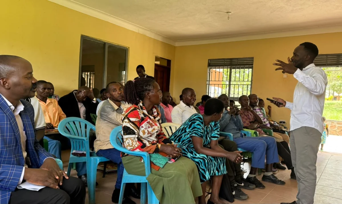 A standing speaker teaching pastors seated with books and notebooks.